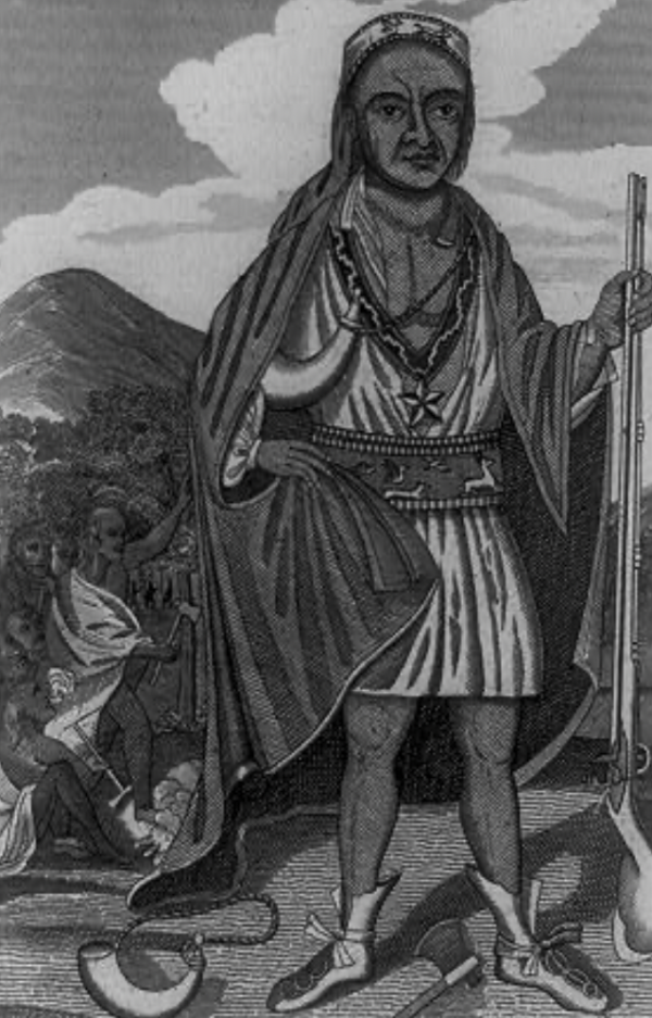 A black-and-white engraving shows a full-body portrait of a Native American leader standing outdoors. He is holding a long staff or spear upright in one hand and wearing layered clothing.