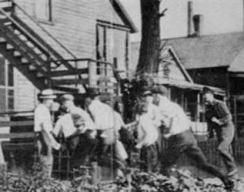 Image: Photo of white Chicagoans looking for African Americans during the race riots of 1919. From the Wikimedia Commons.